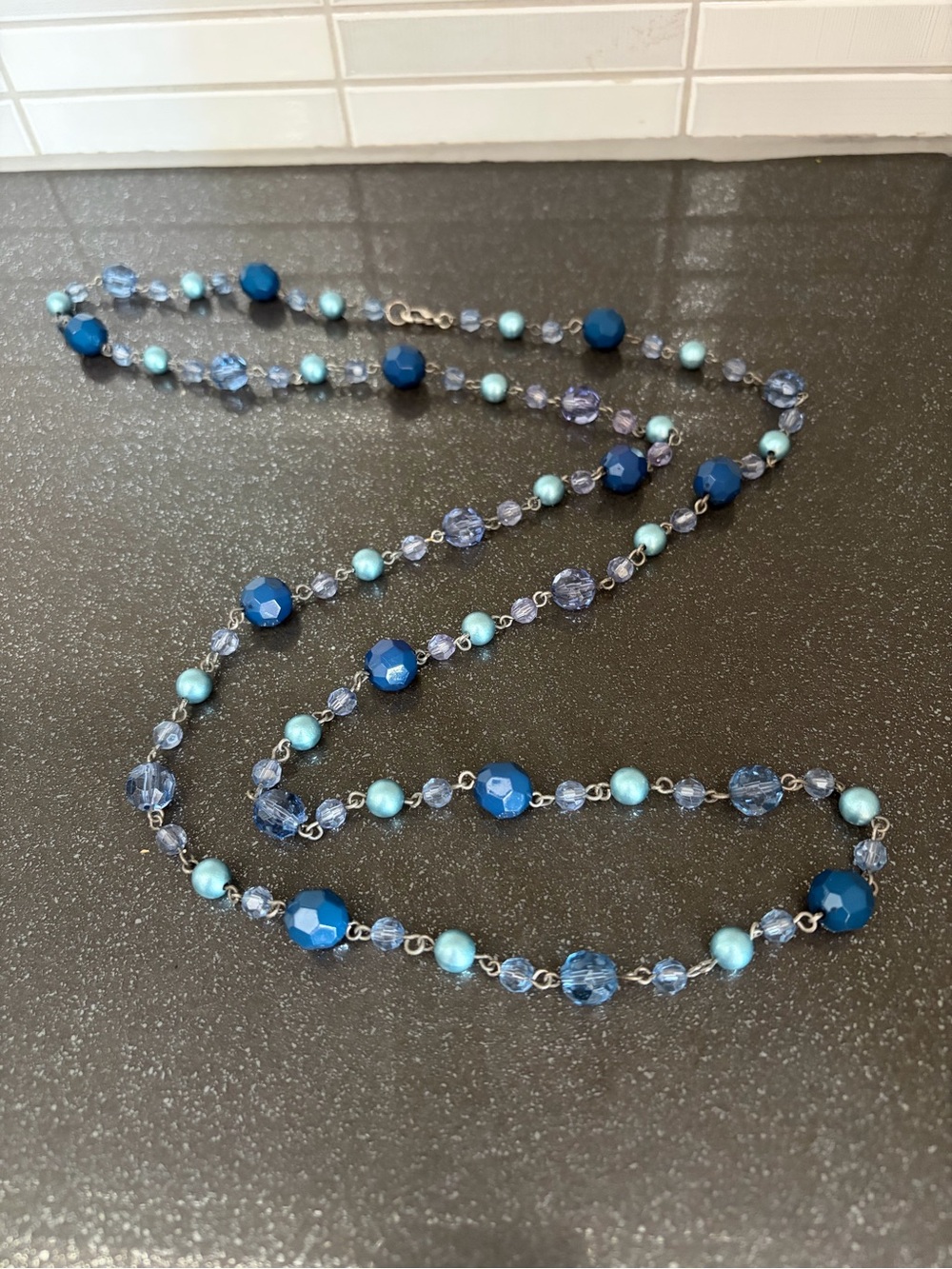 Womenโs beaded and silver coloured necklace
